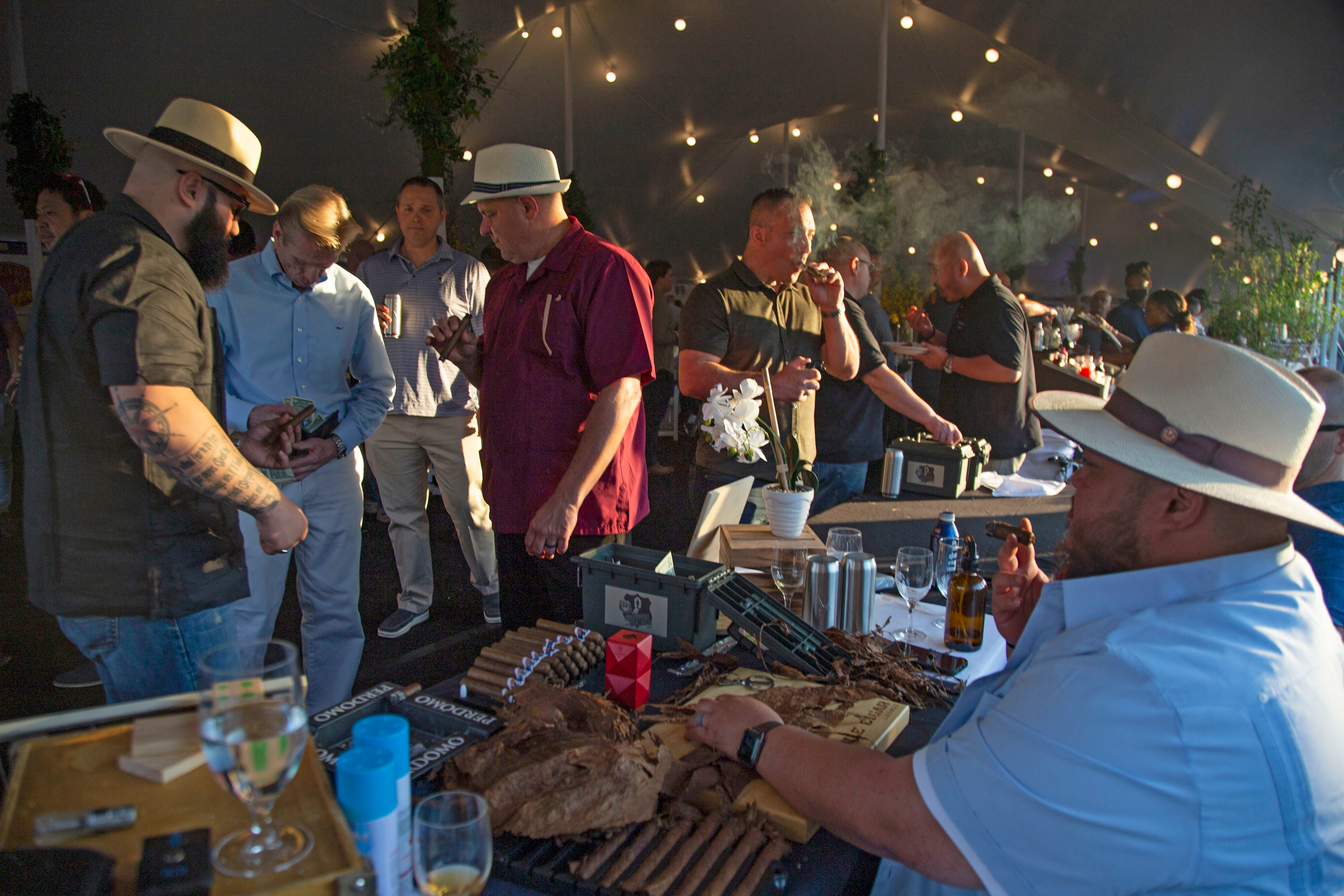Men wearing Panama hats smoking cigars