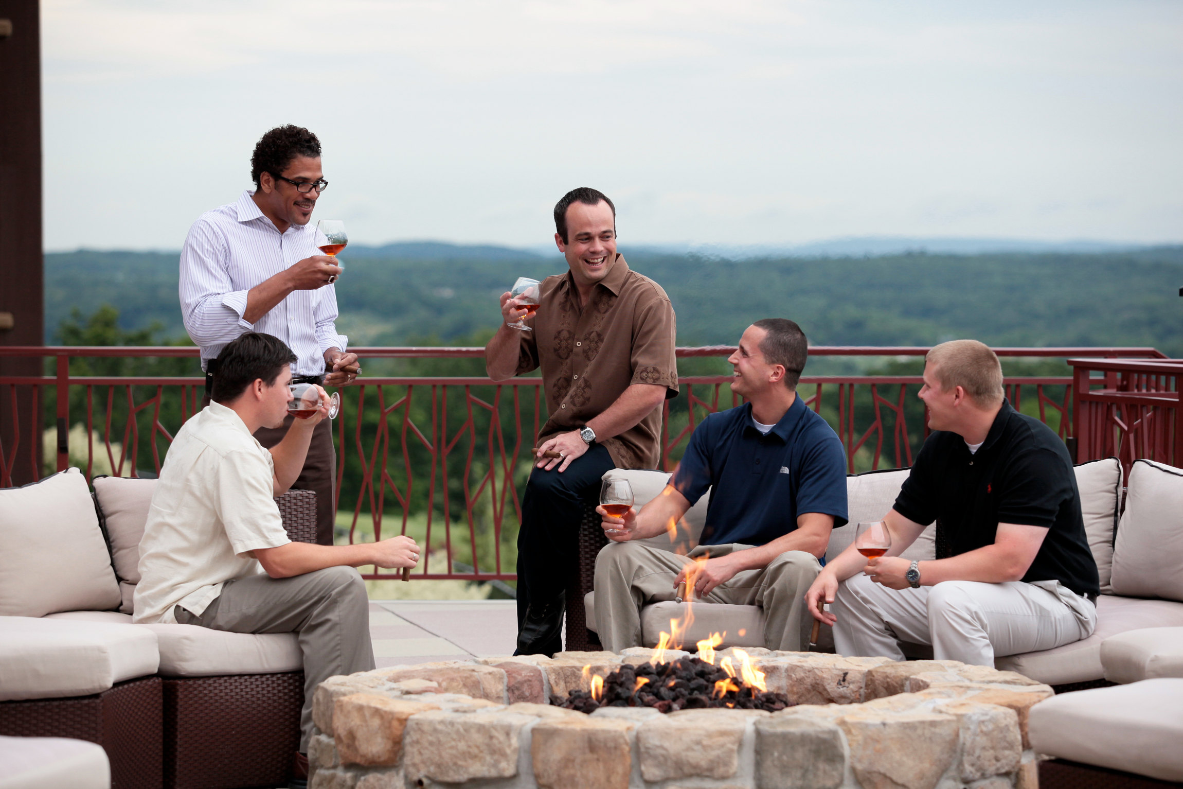 Group of guys hanging out by the firepit