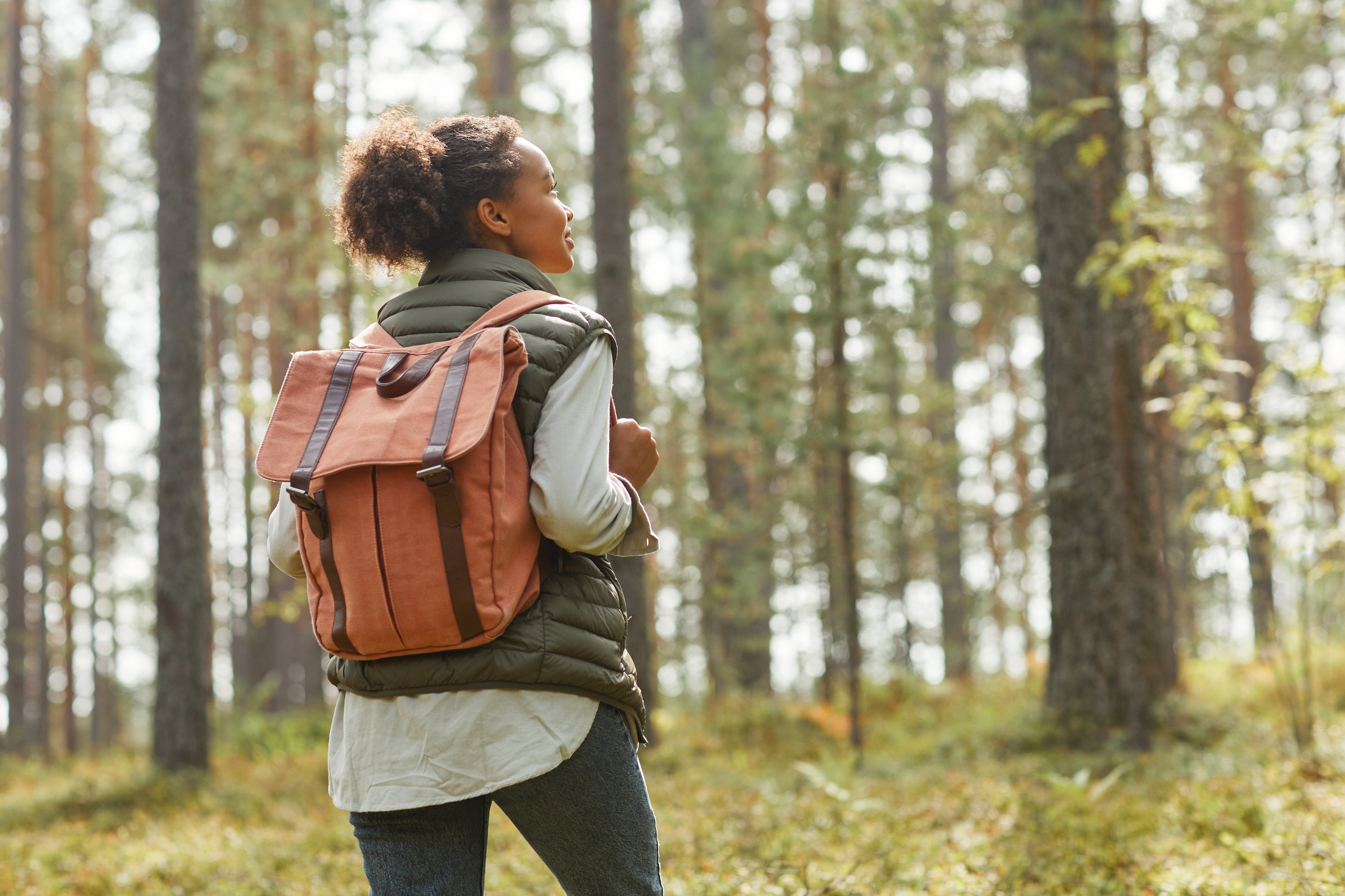 Woman hiking through forest in Sussex County.