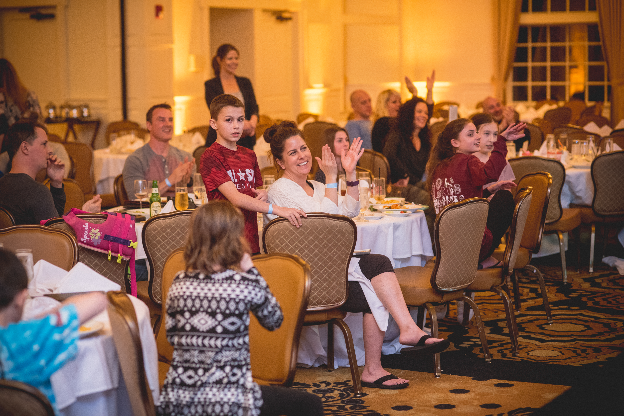 Families enjoying dinner and a show