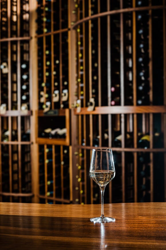 Glass of white wine in the Curator