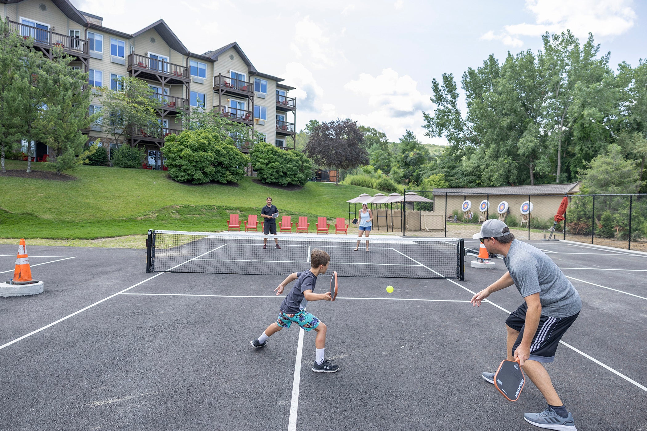 Family playing pickleball.