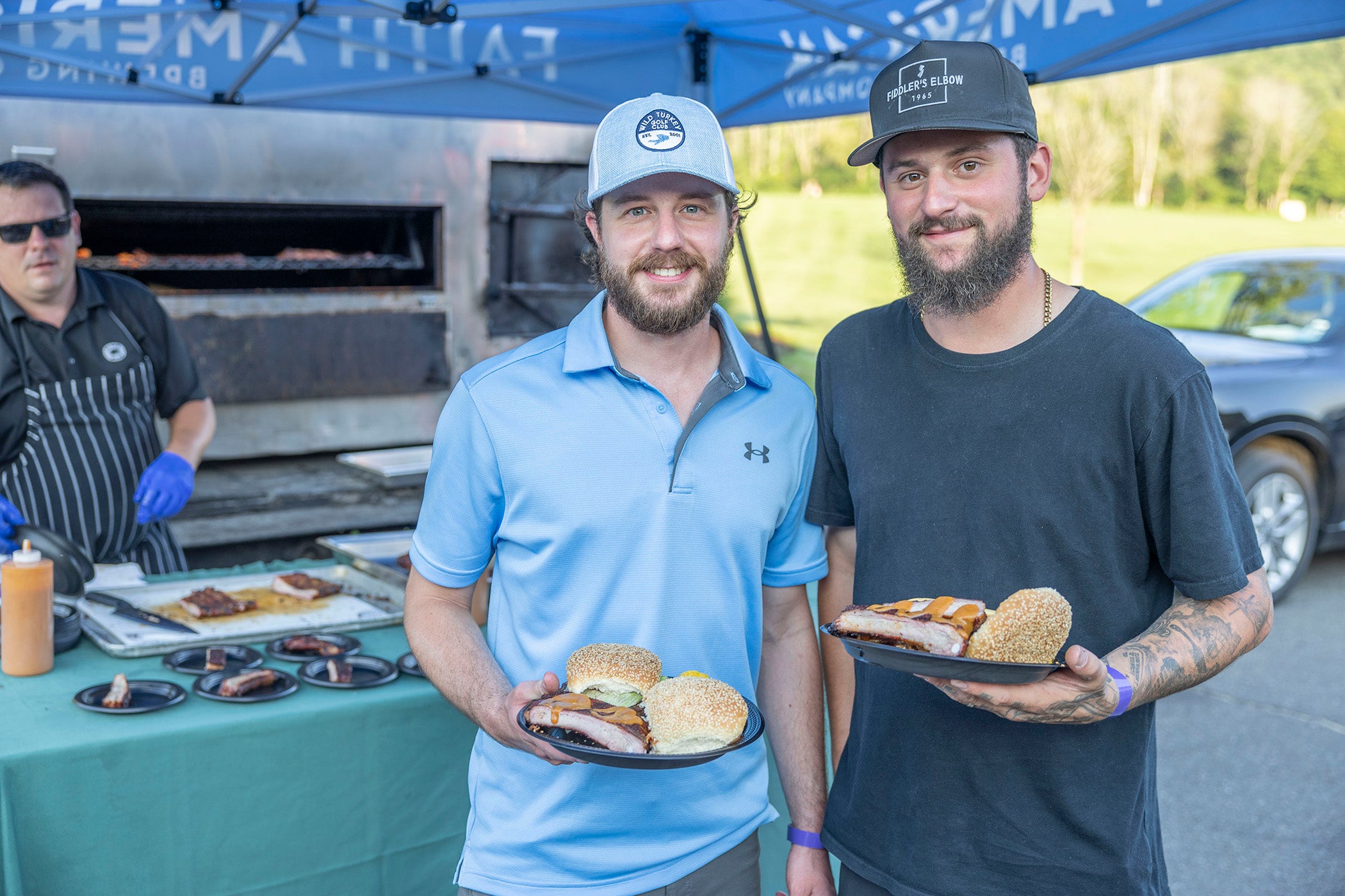 Two men with plates of food. 