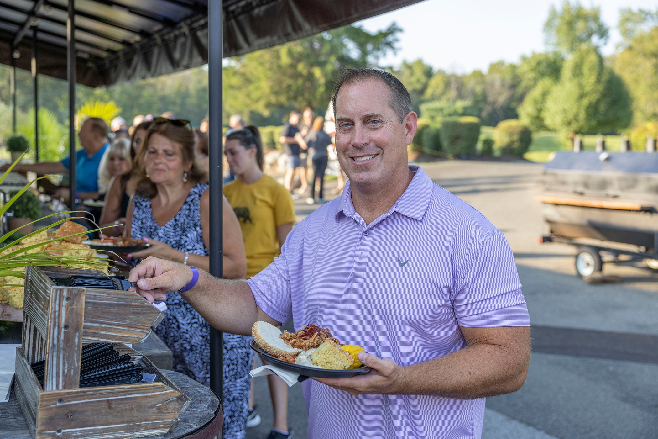 Man grabbing food from buffet.