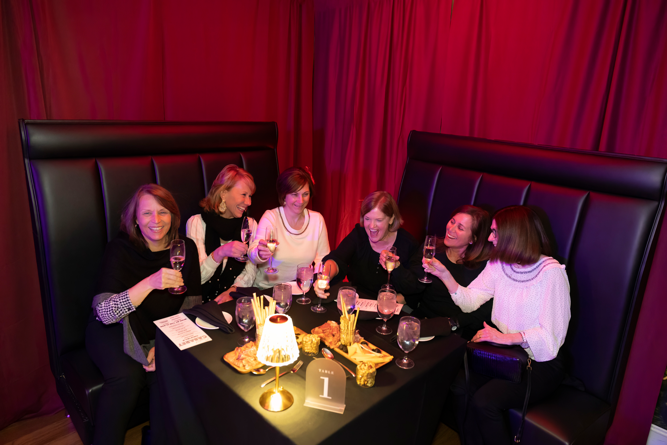 Group of girlfriends enjoying drinks at Crystal Cabaret. 