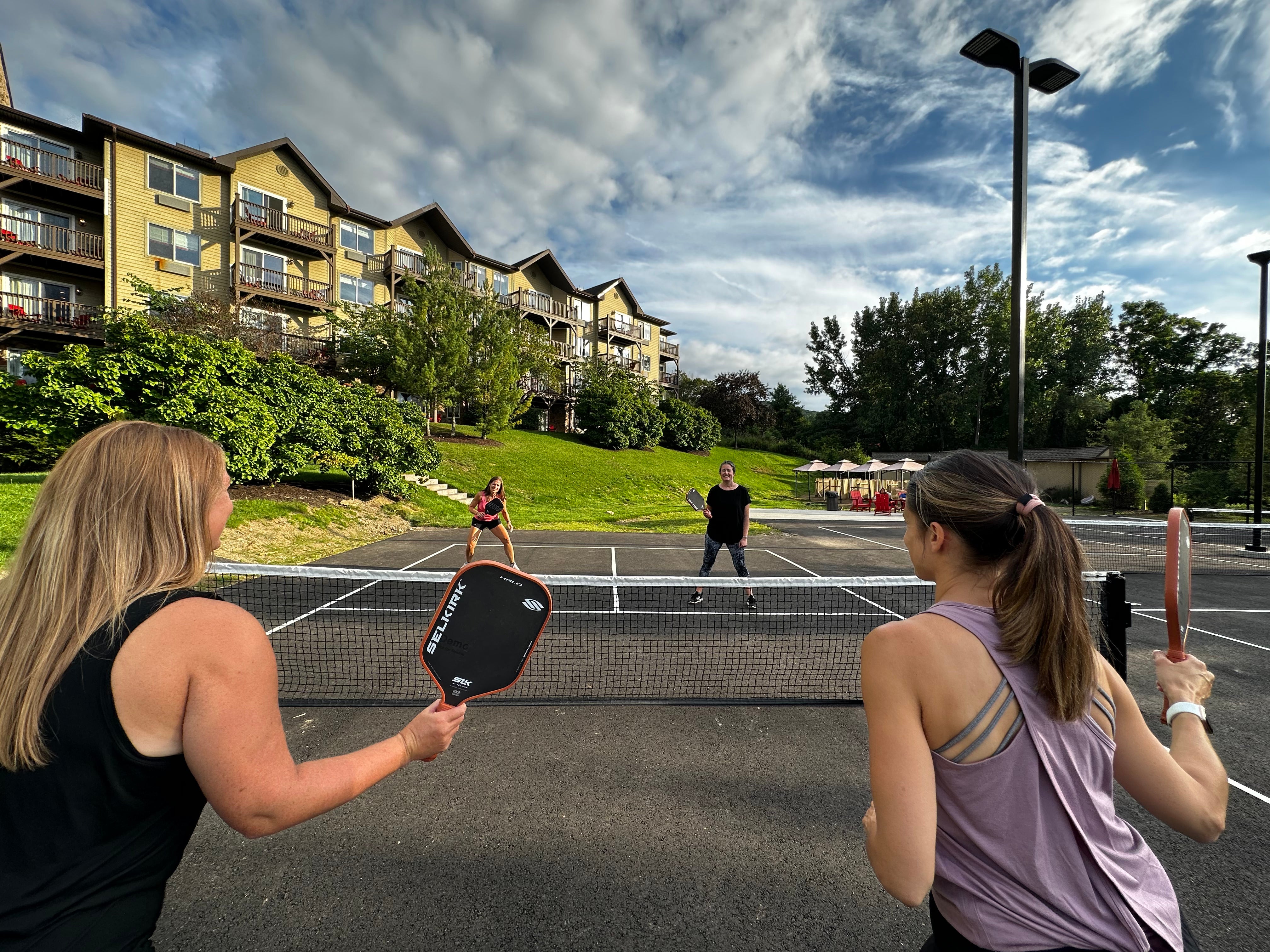 Group of women playing pickleball.