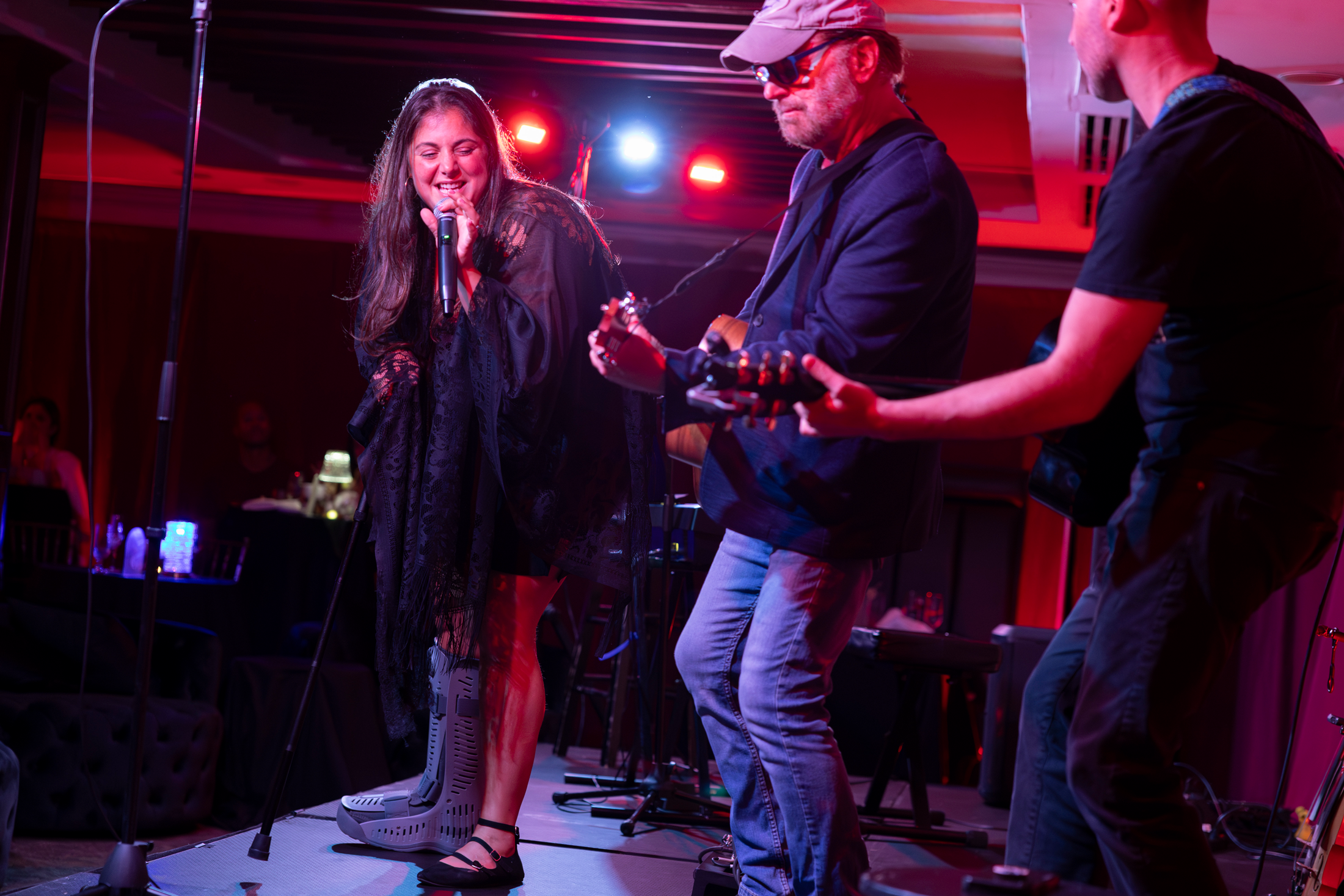 Singer and two guitar players on stage at Crystal Cabaret.