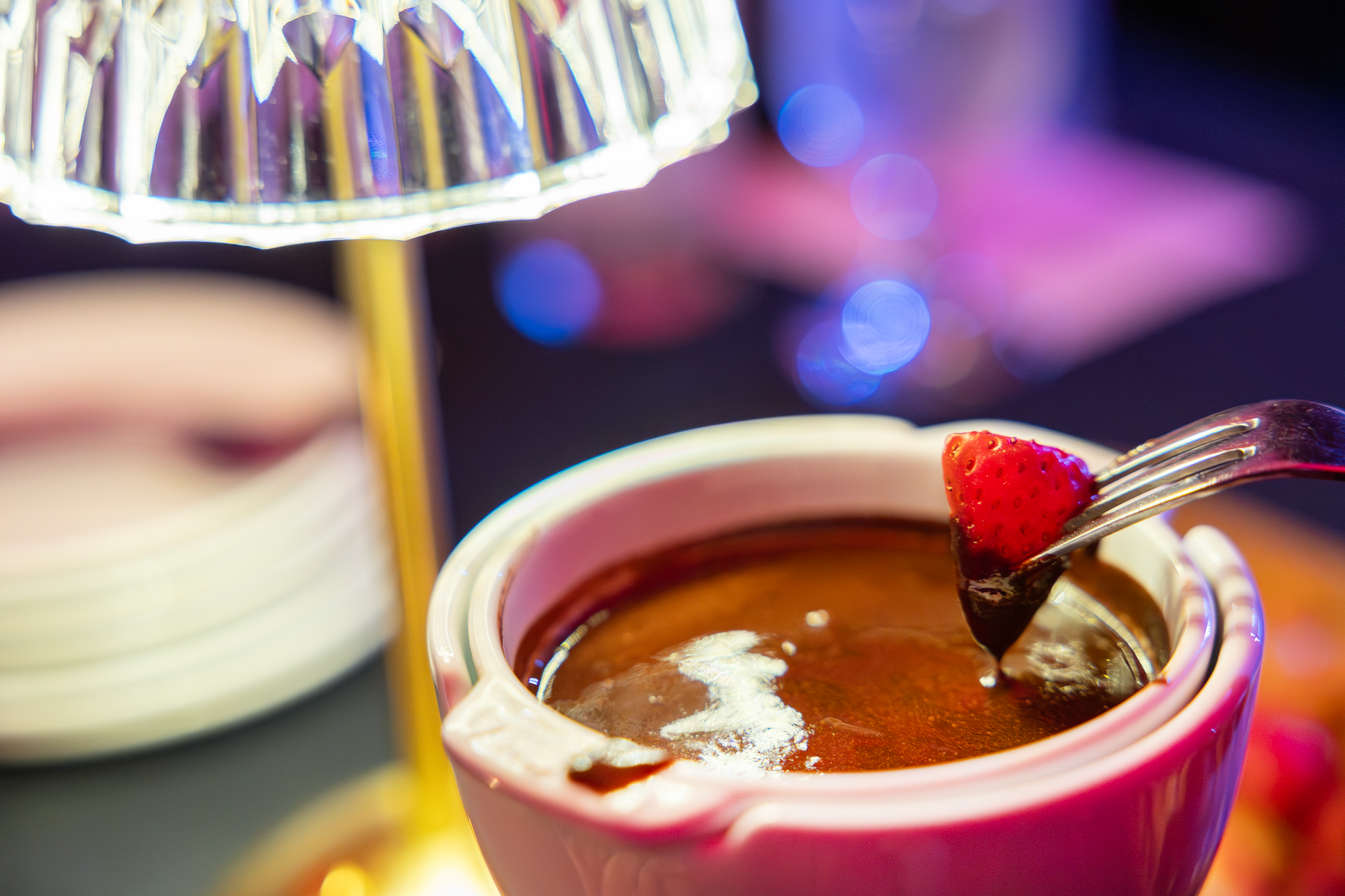 Strawberry being dipped in chocolate at Crystal Cabaret.