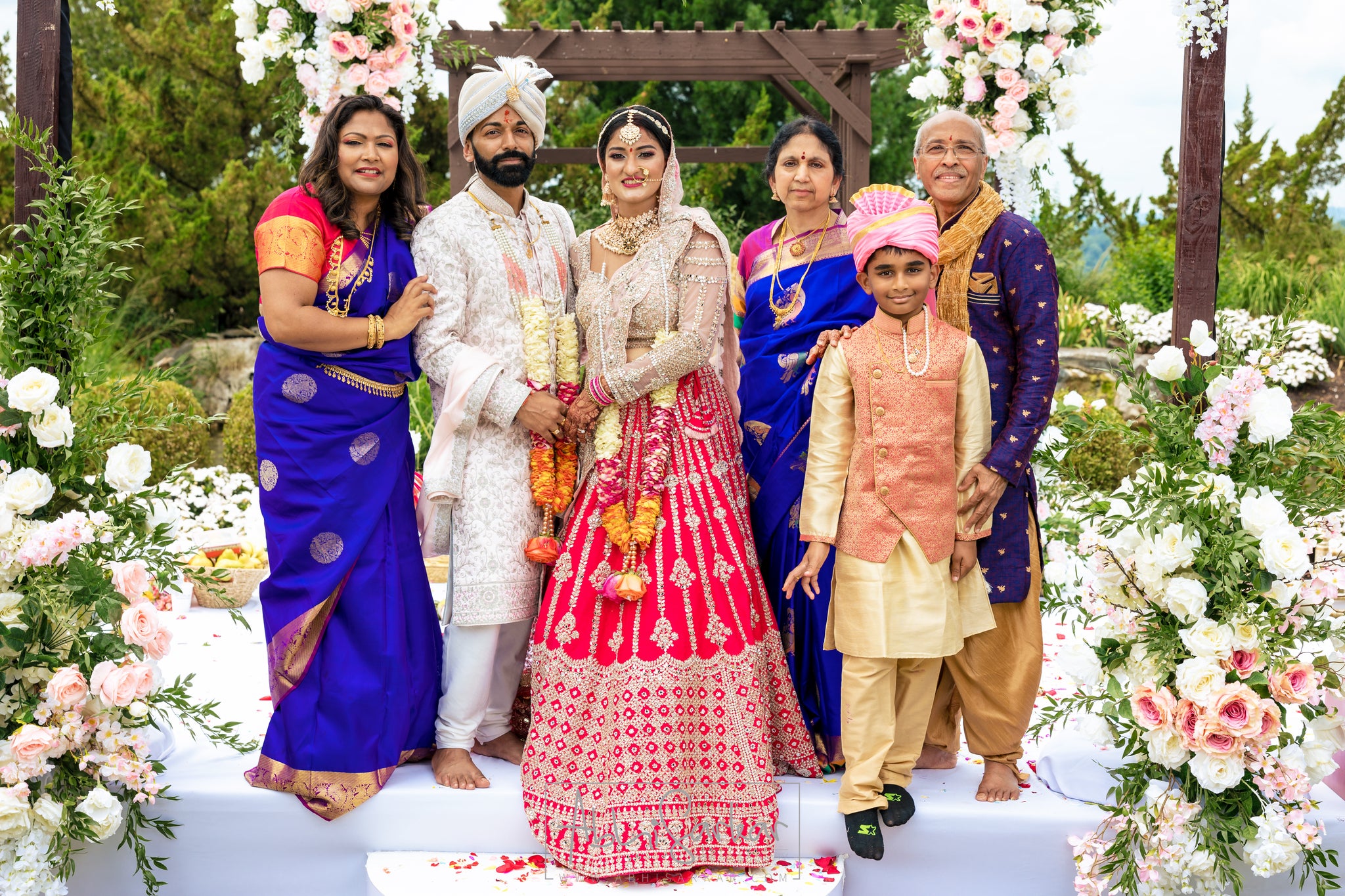 Indian couple standing with their family after getting married at Crystal Springs Resort.