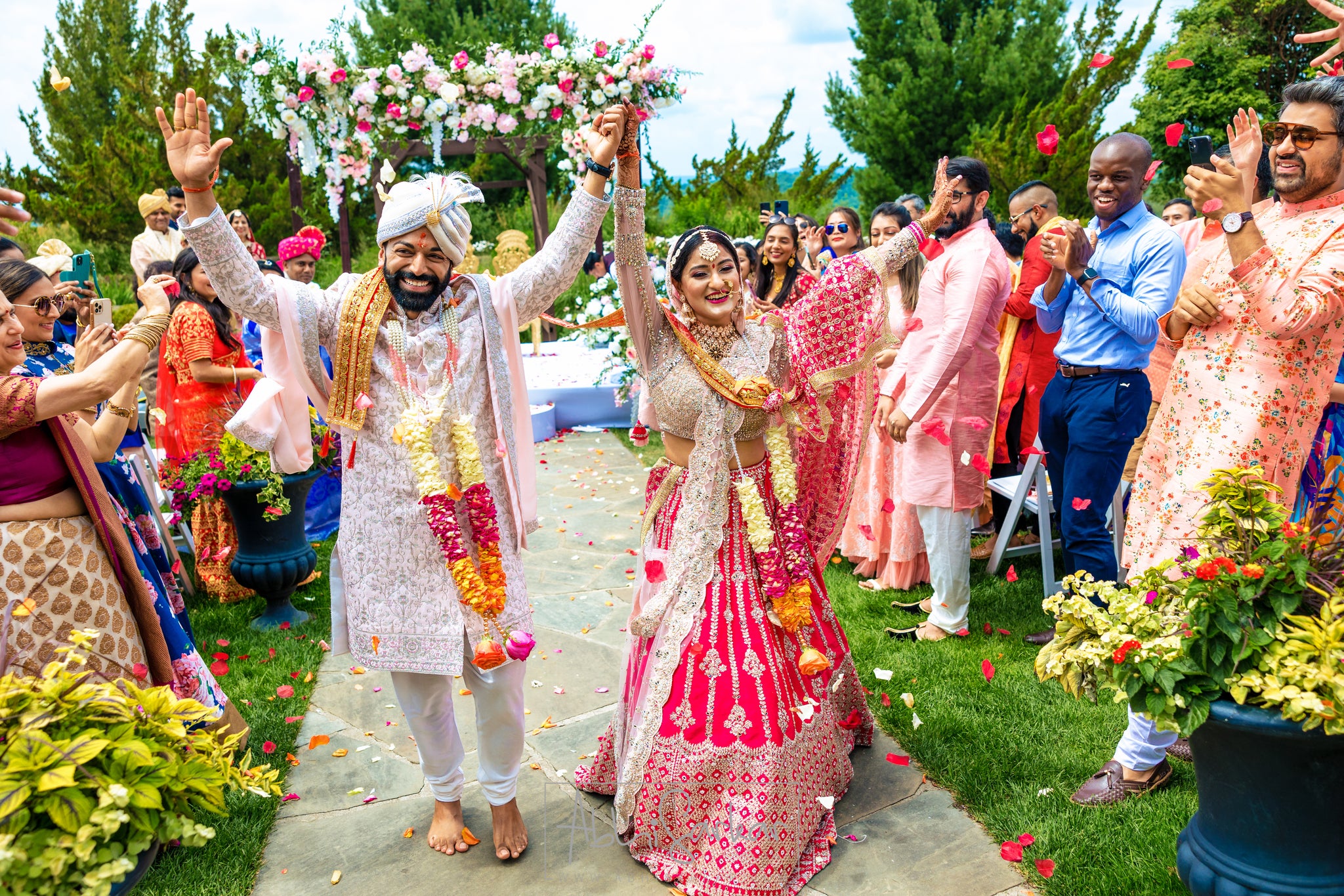 Newly married couple walking down aisle during their Indian wedding ceremony.