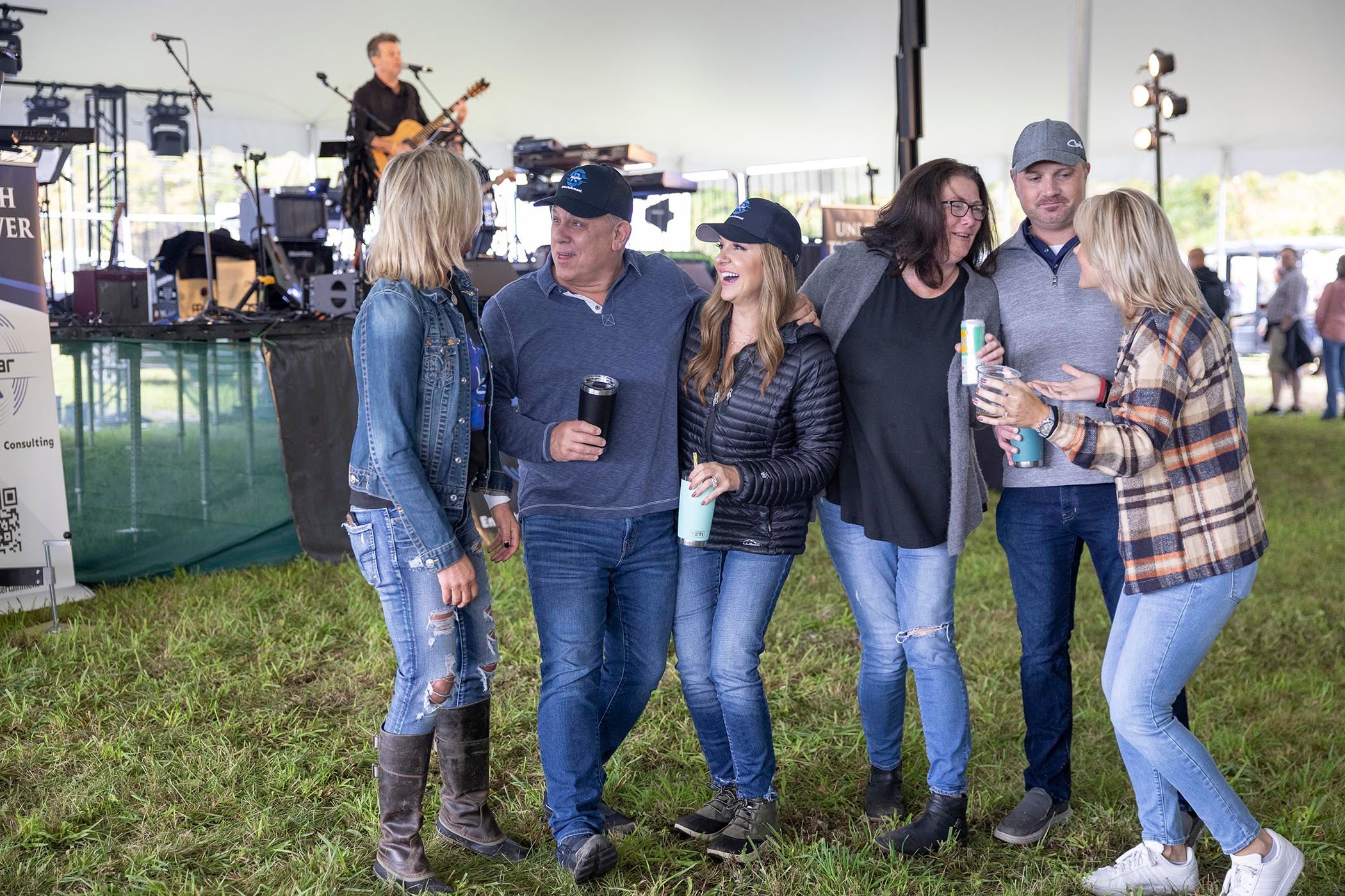 Group of friends laughing together at music fest.