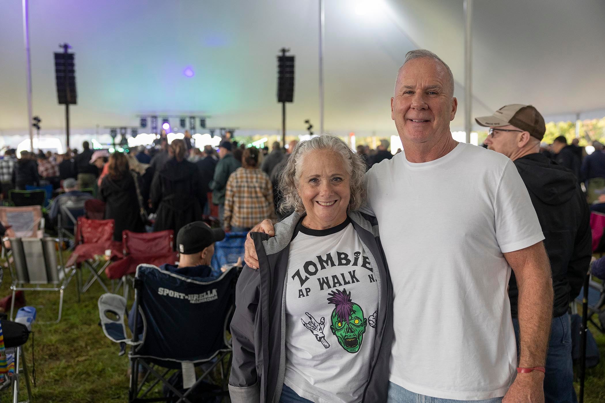 Man and woman standing together with music fest crown behind them.