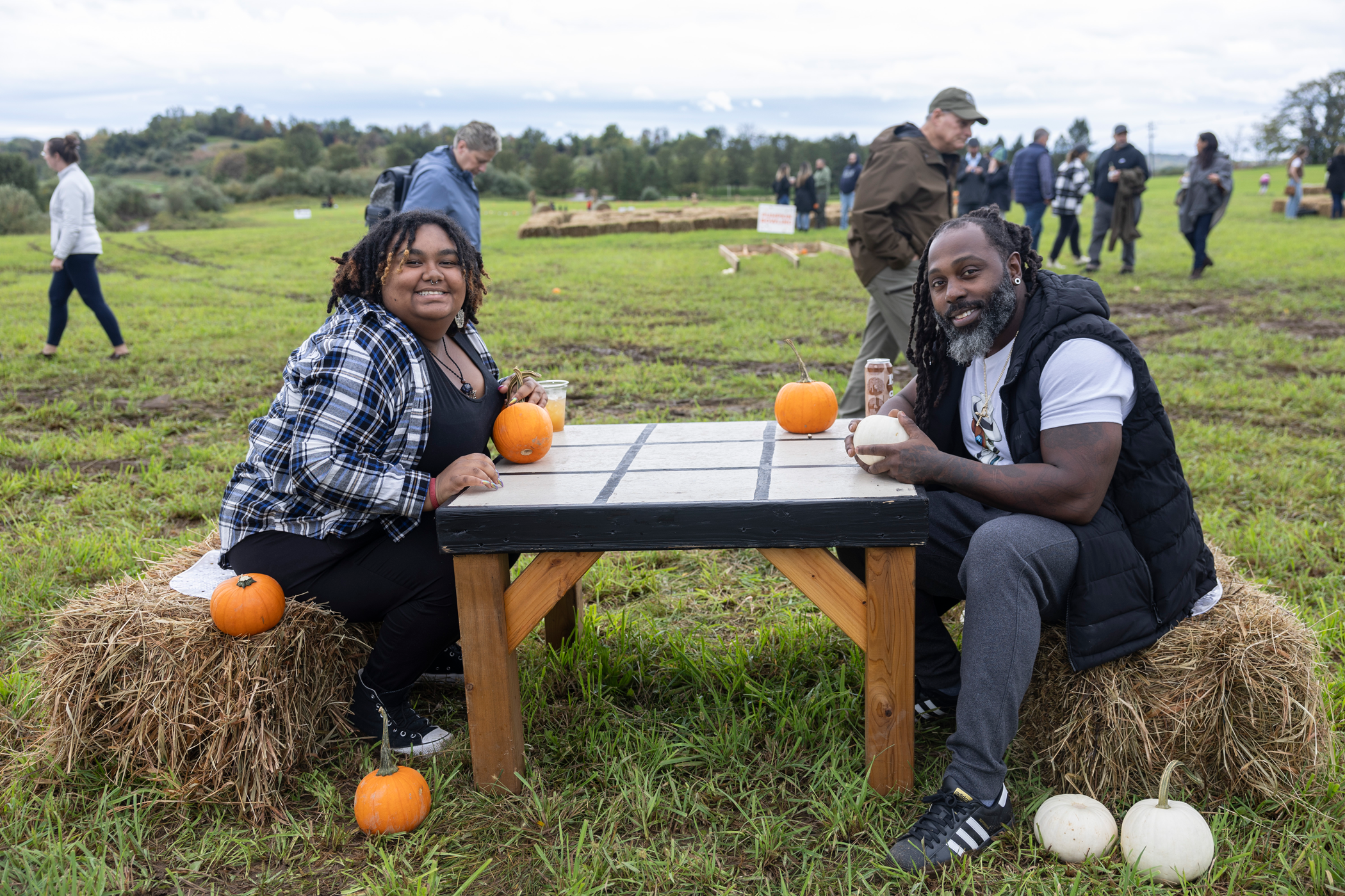 Woman and man playing tic tac toe with pumpkins 