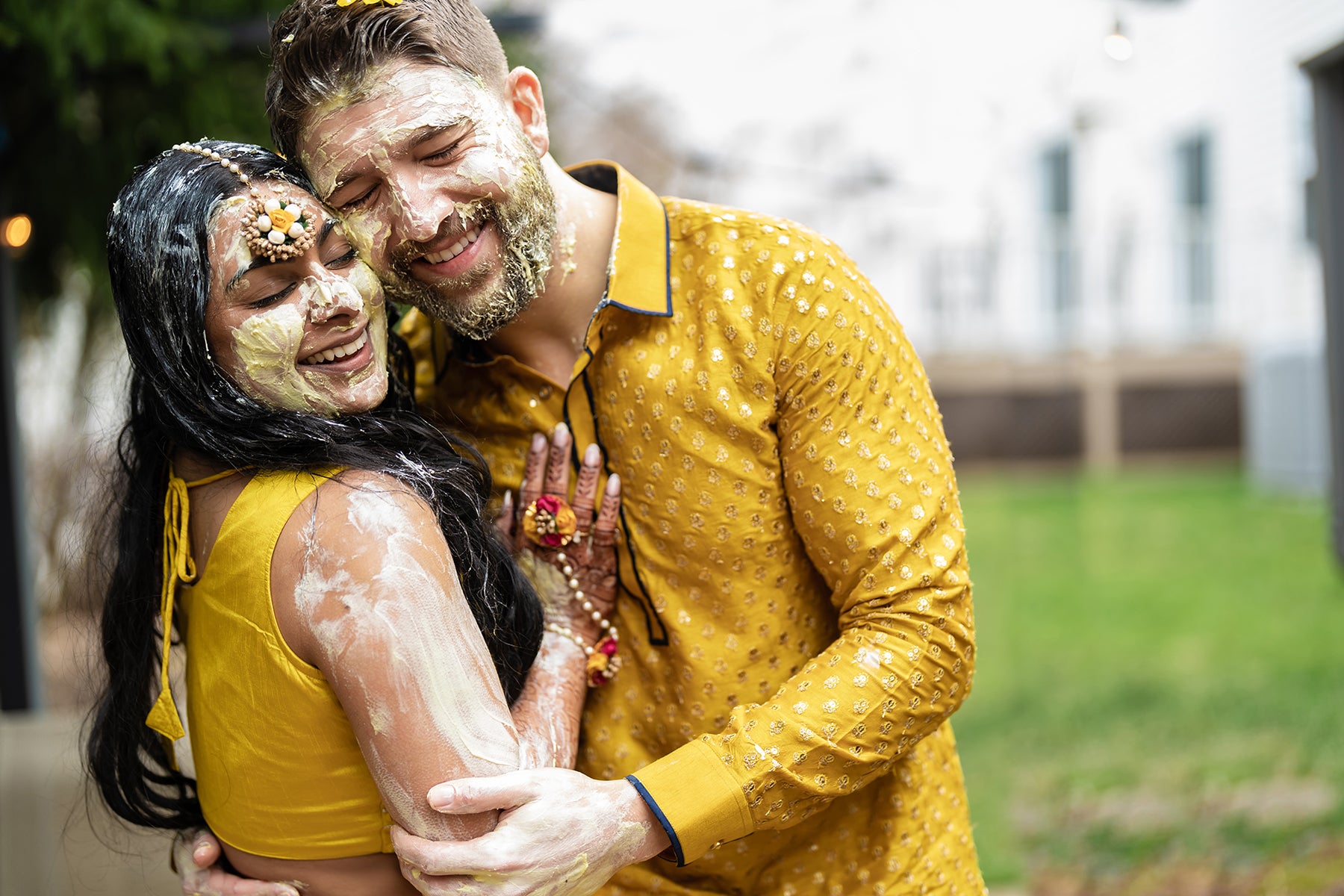 Indian bride and groom wearing gold sarees