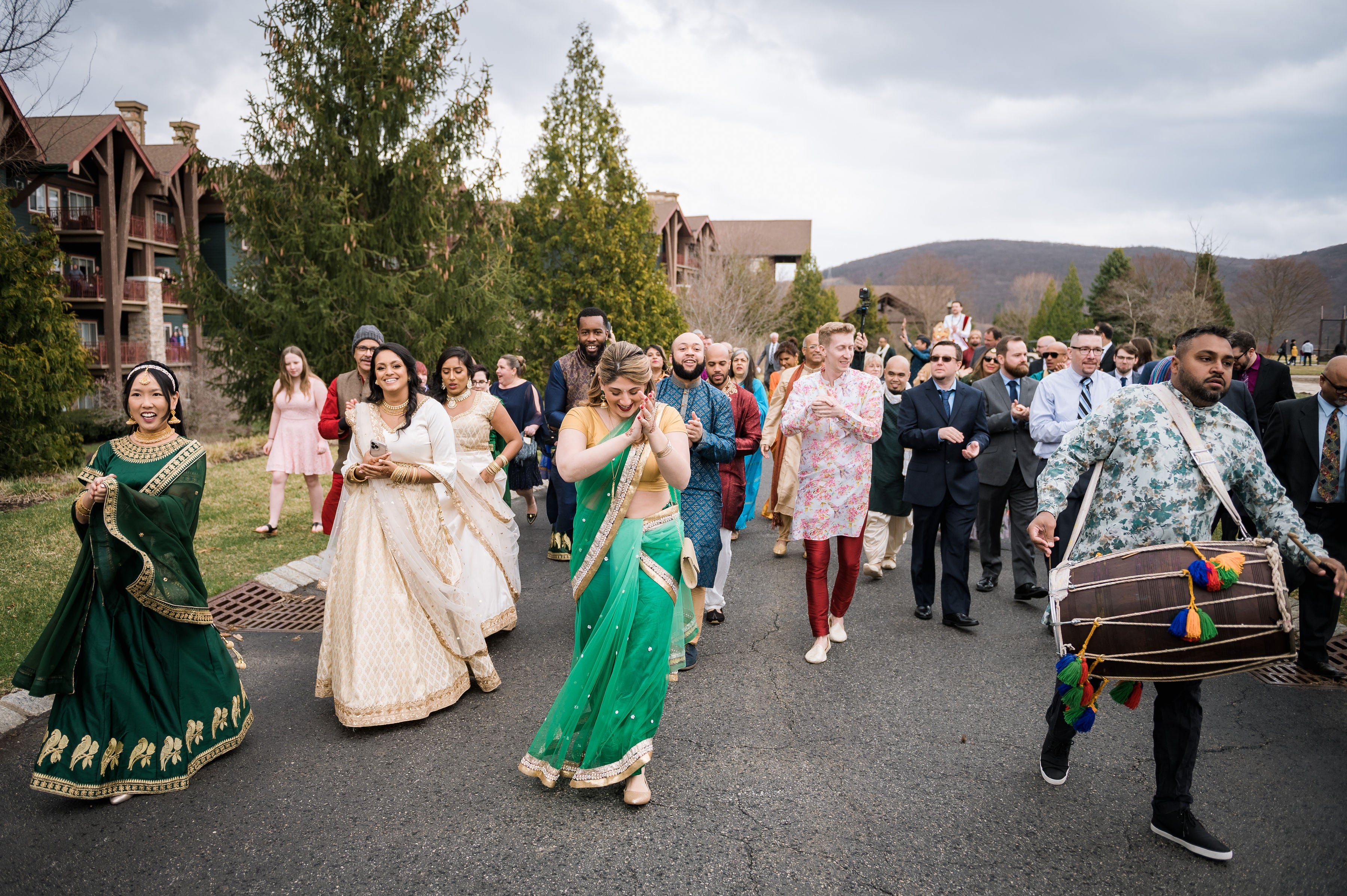 Guests of Indian wedding ceremony walking in front of Grand Cascades Lodge.
