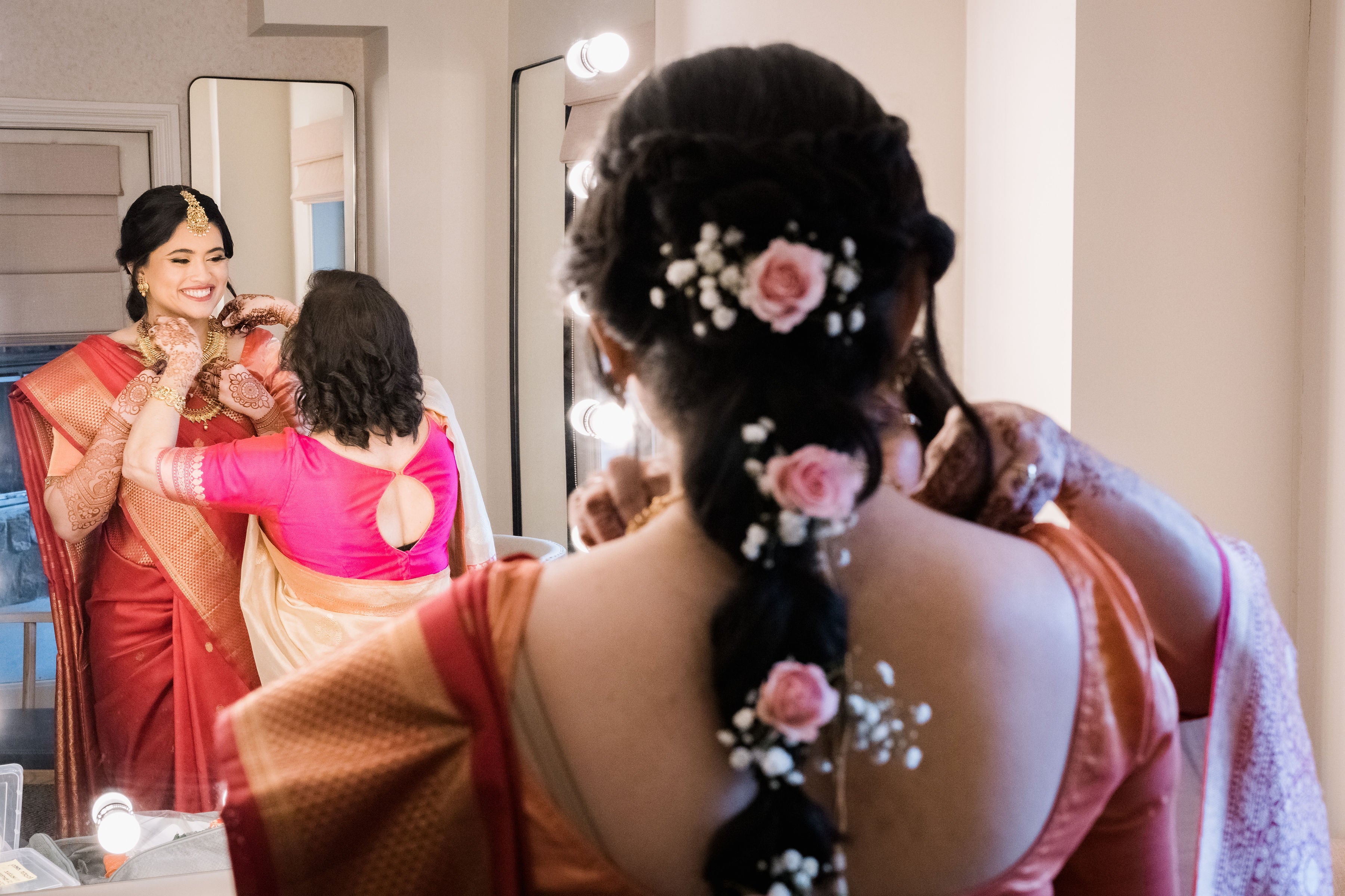 Indian bride's hair featuring pink flowers.