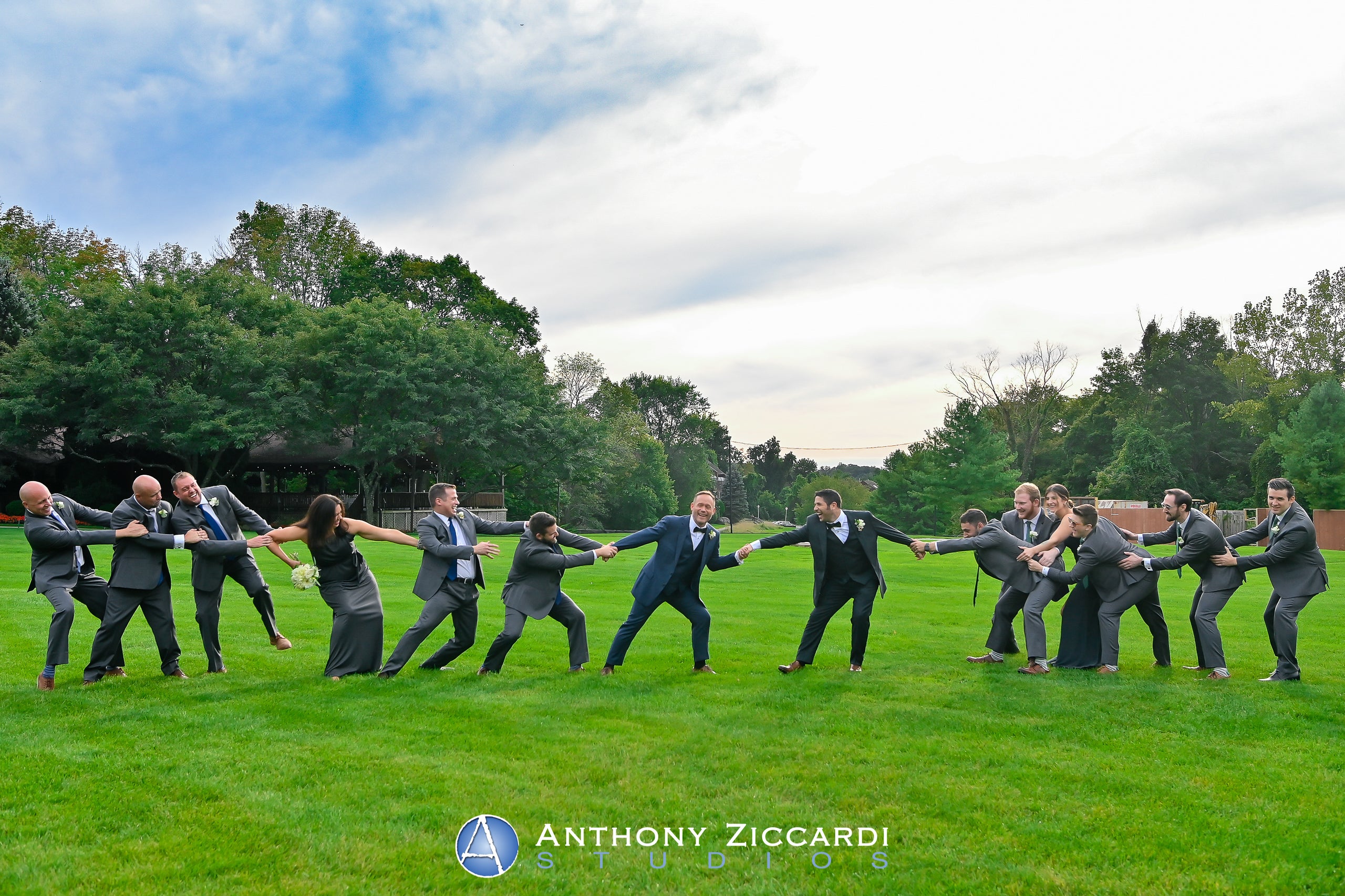 Grooms being pulled by their wedding party.