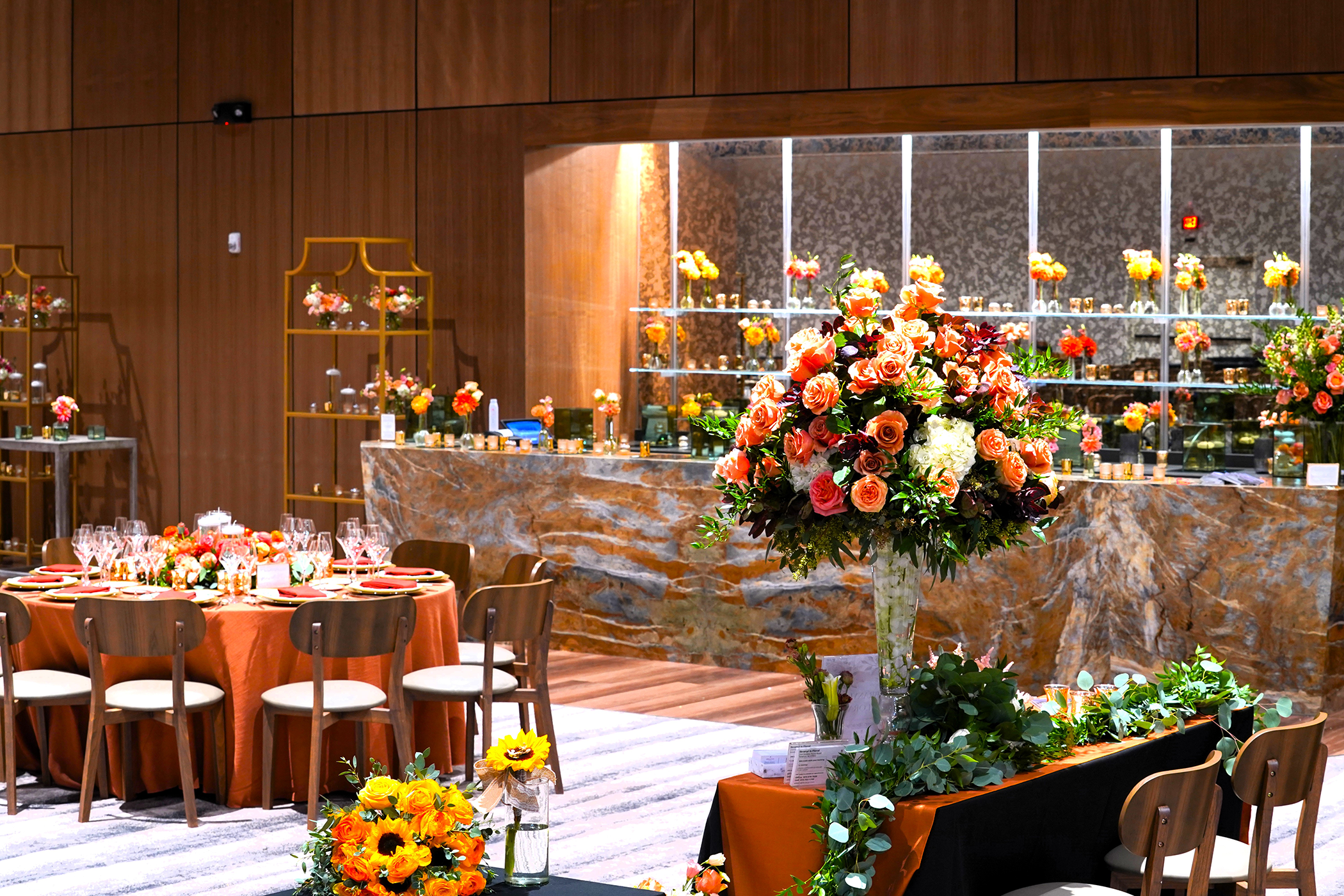 Wedding reception set up featuring orange and pink florals in the Canyon Ballroom.