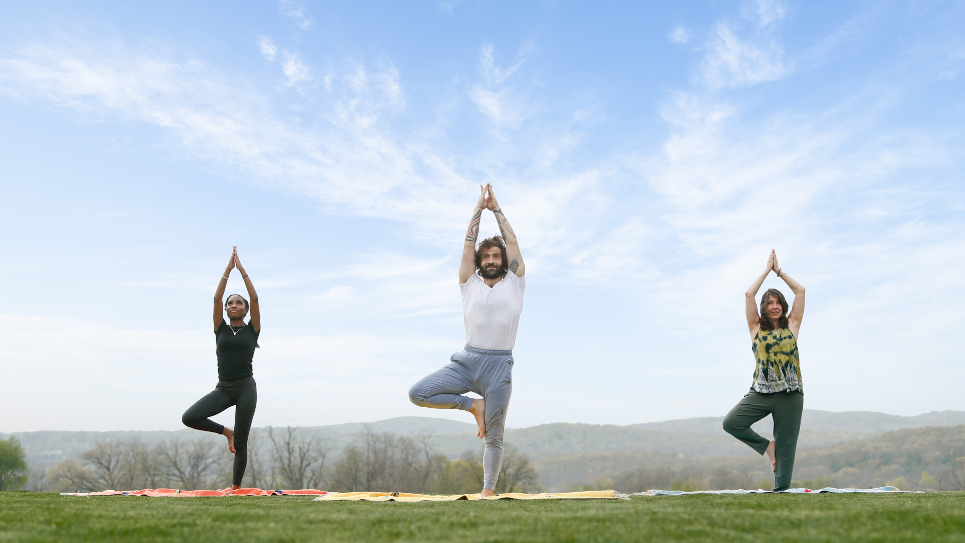 Three people in yoga pose.