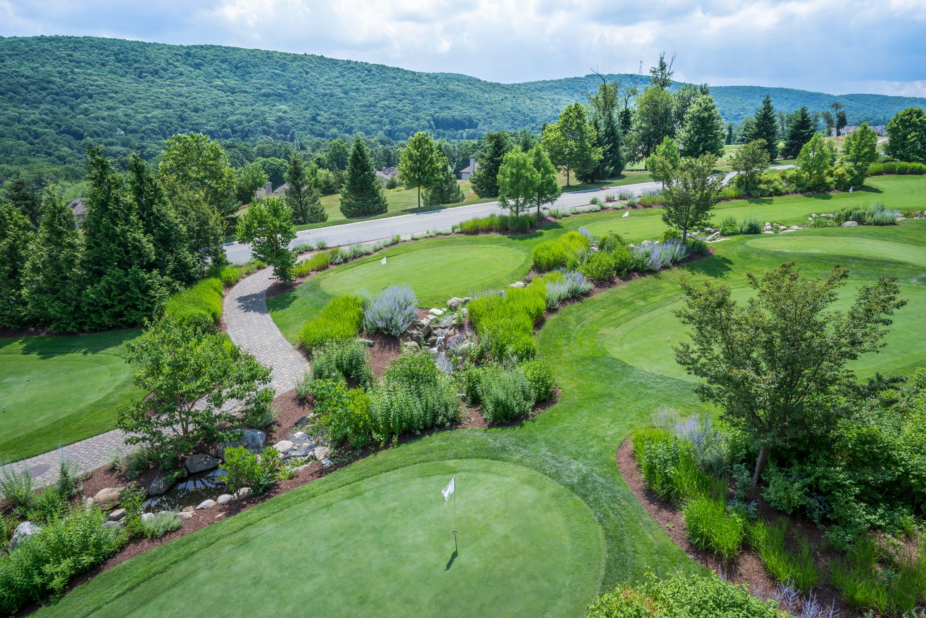 Natural grass putting course and mountain view at Grand Cascades Lodge.