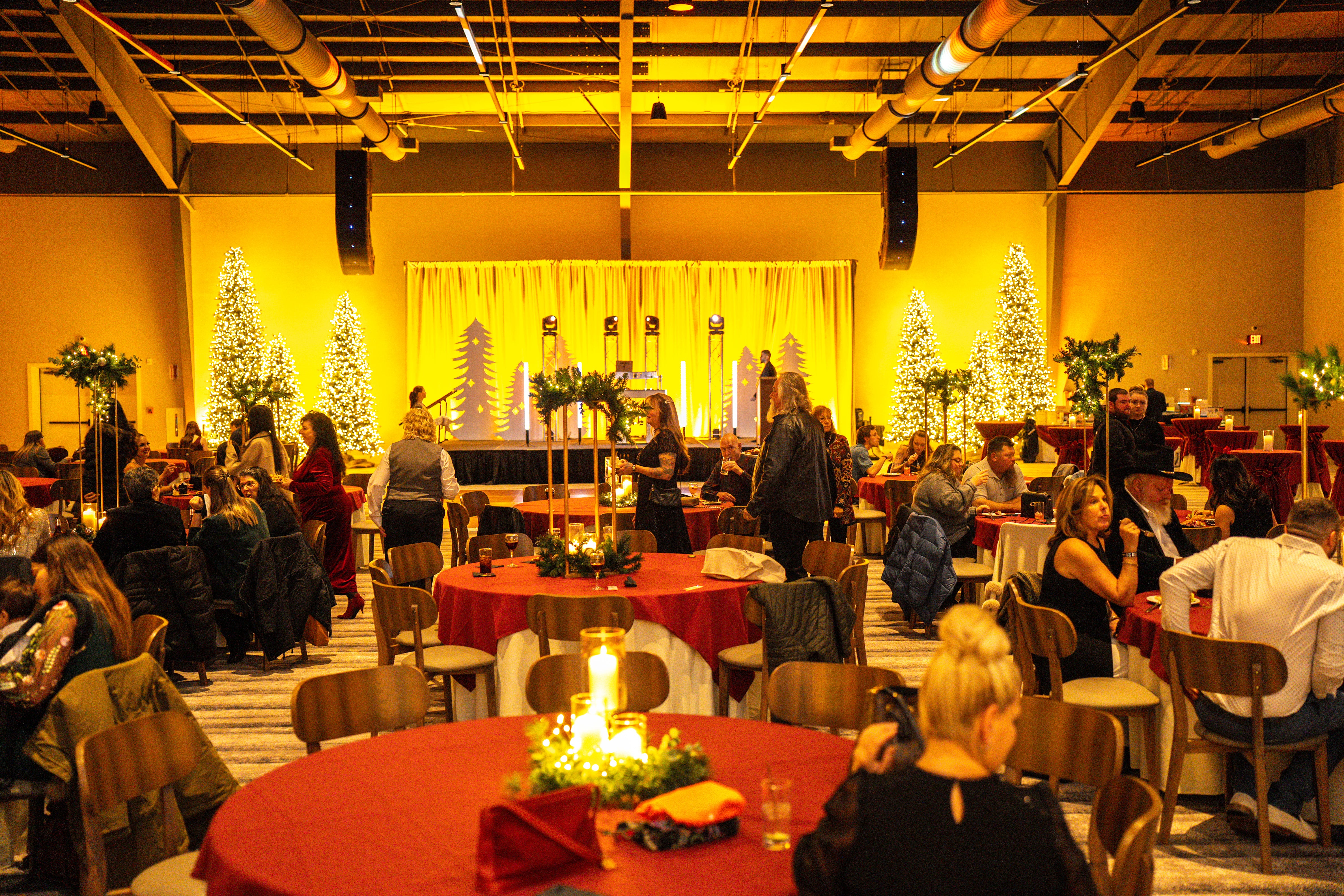 Round tables with people dining set up in Canyon Ballroom.