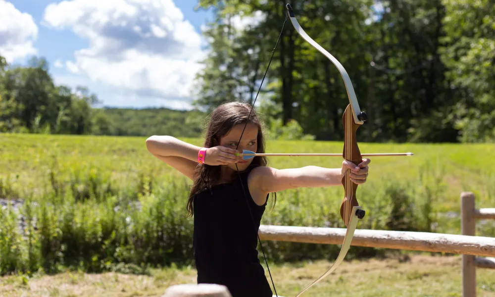 Girl shooting an arrow. 