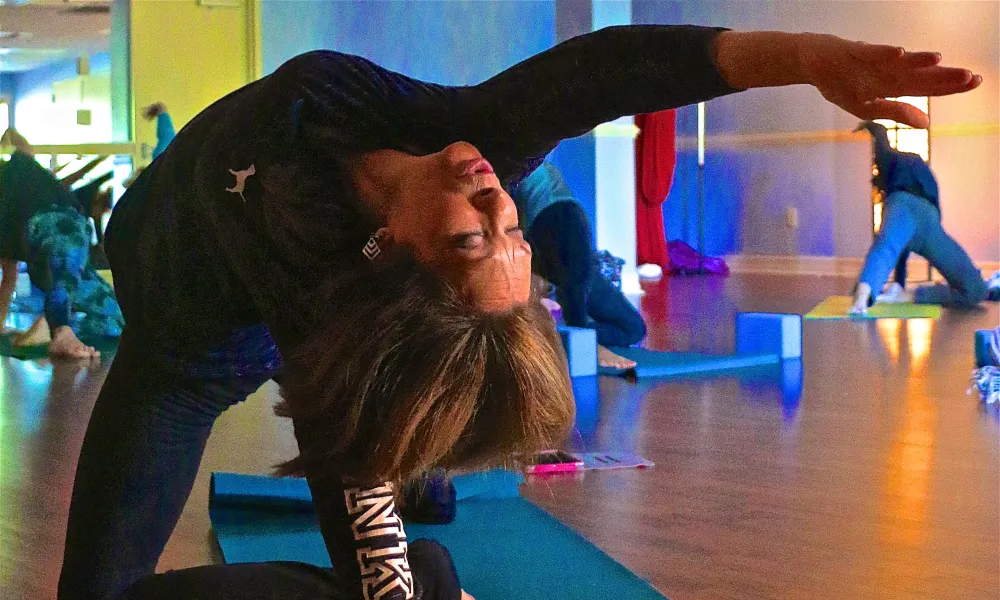Woman reaching arm backwards during yoga.