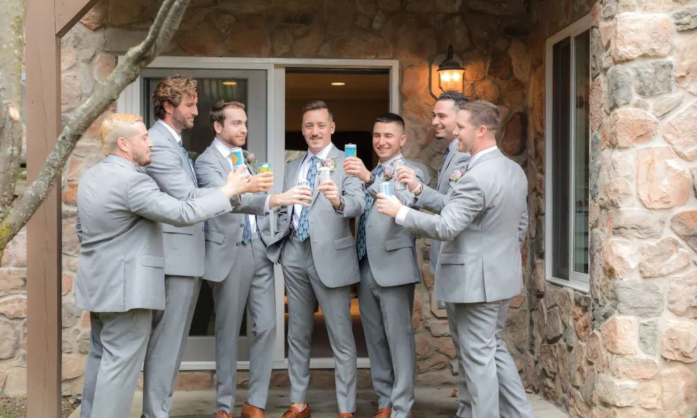 Group of groomsmen cheersing.