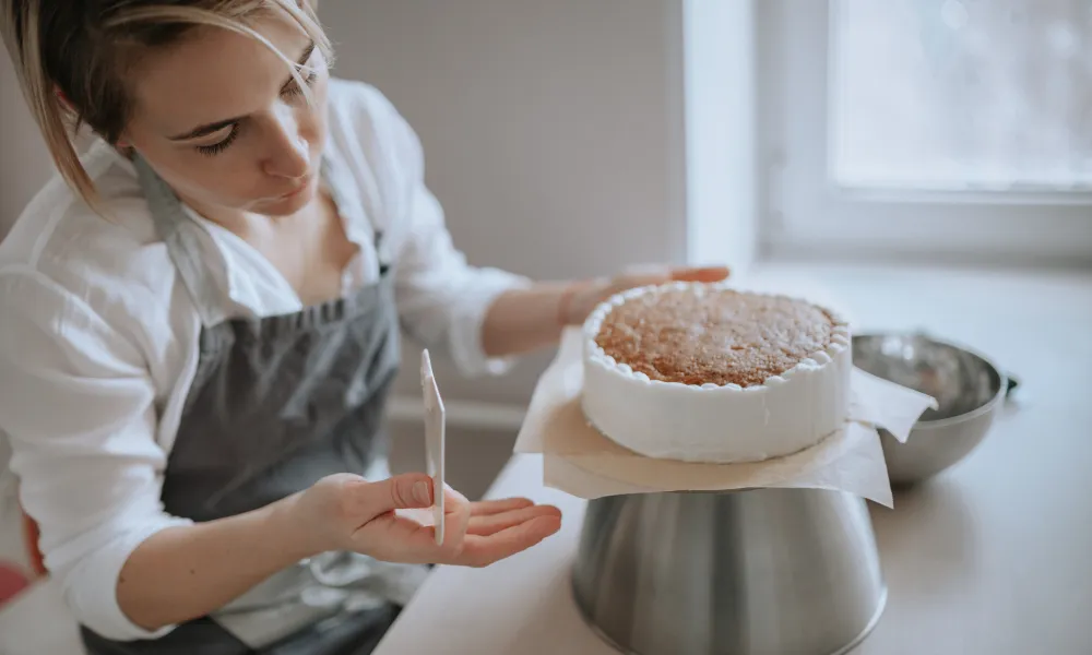 Baker preparing cake. 