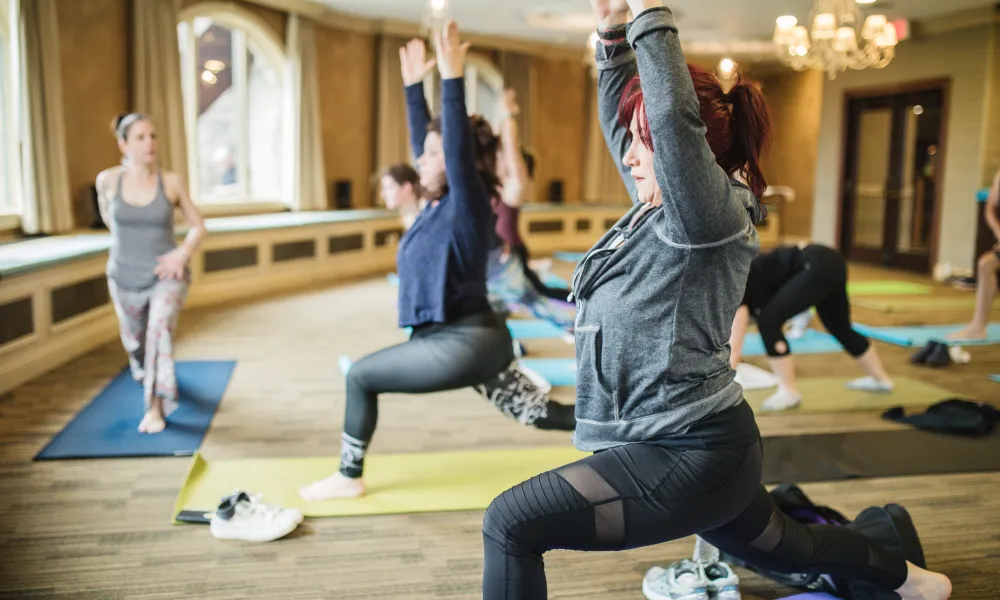 Women in forward warrior yoga pose