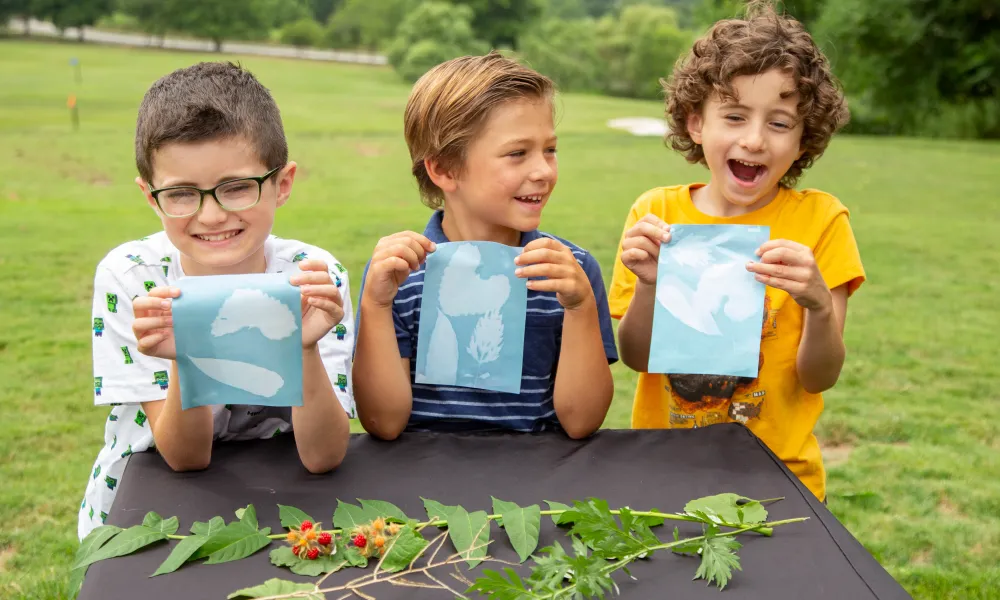Kids holding their solar art prints.