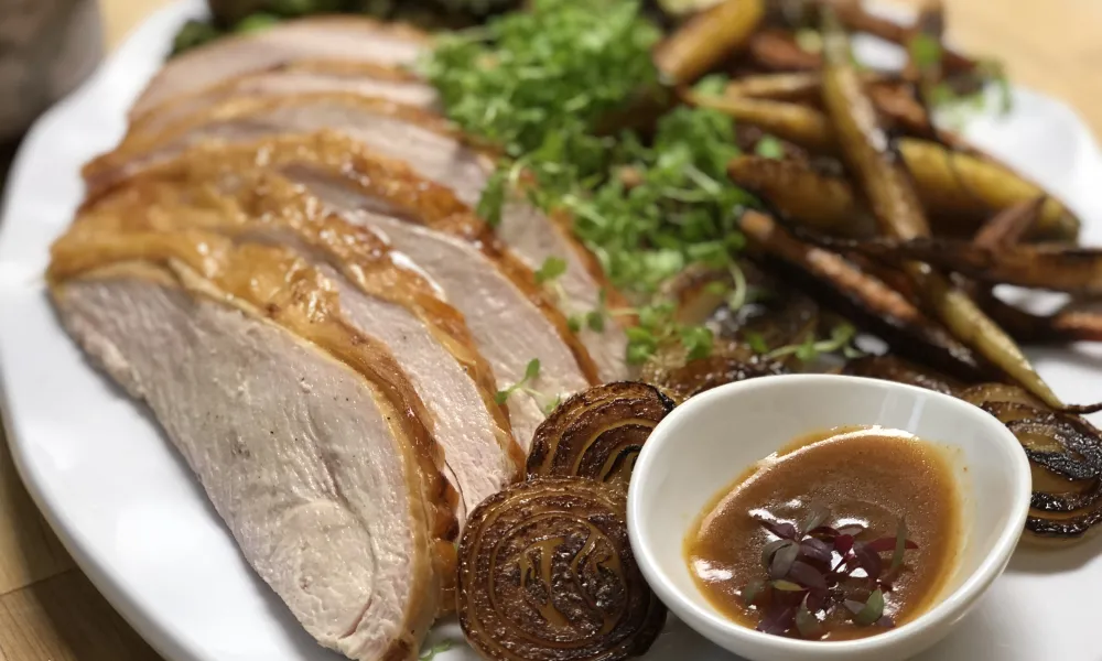 Thanksgiving plate with sliced turkey, gravy, and vegetables