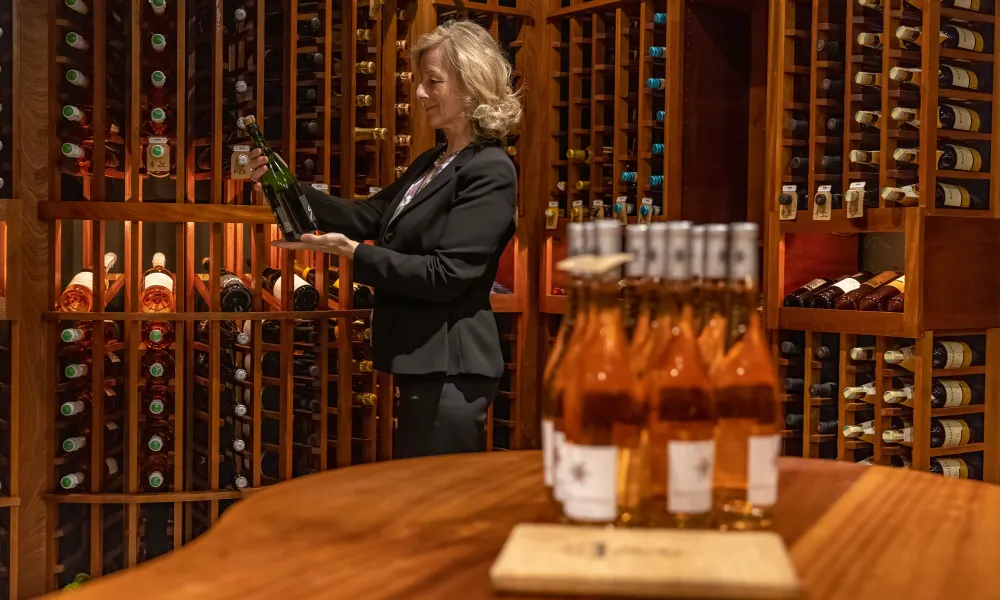Sommelier selecting wine at The Curator 