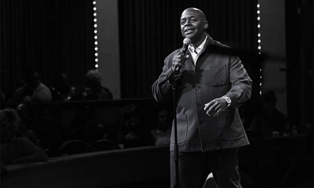 Brad Lowery on stage with microphone.