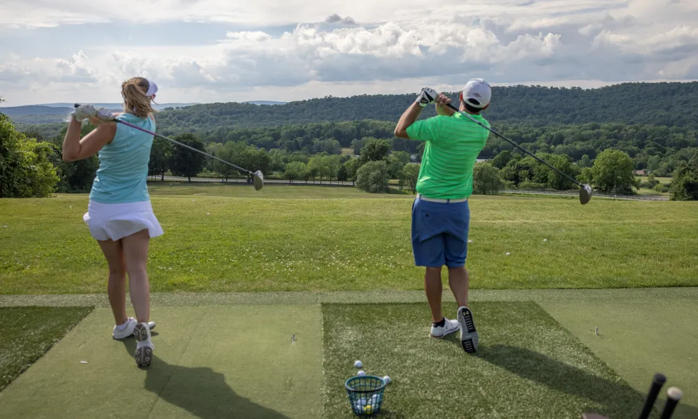 Golfers at the driving range at Crystal Springs Resort