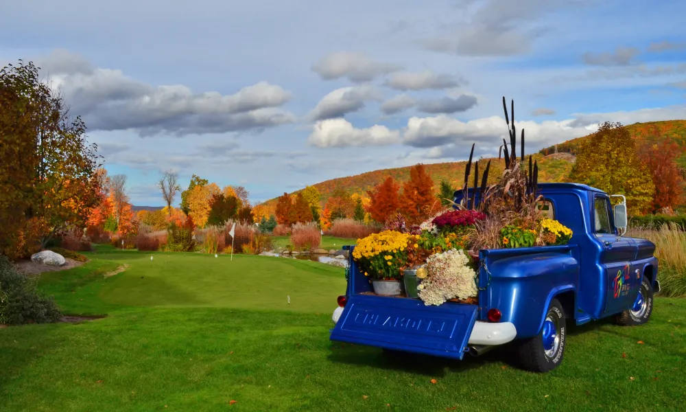 The Crystal Springs Blue truck on the natural grass putting course at Grand Cascades Lodge