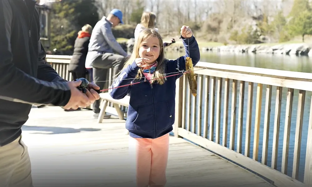 Young girl holding fish at the Quarry at Minerals Hotel in Sussex County.