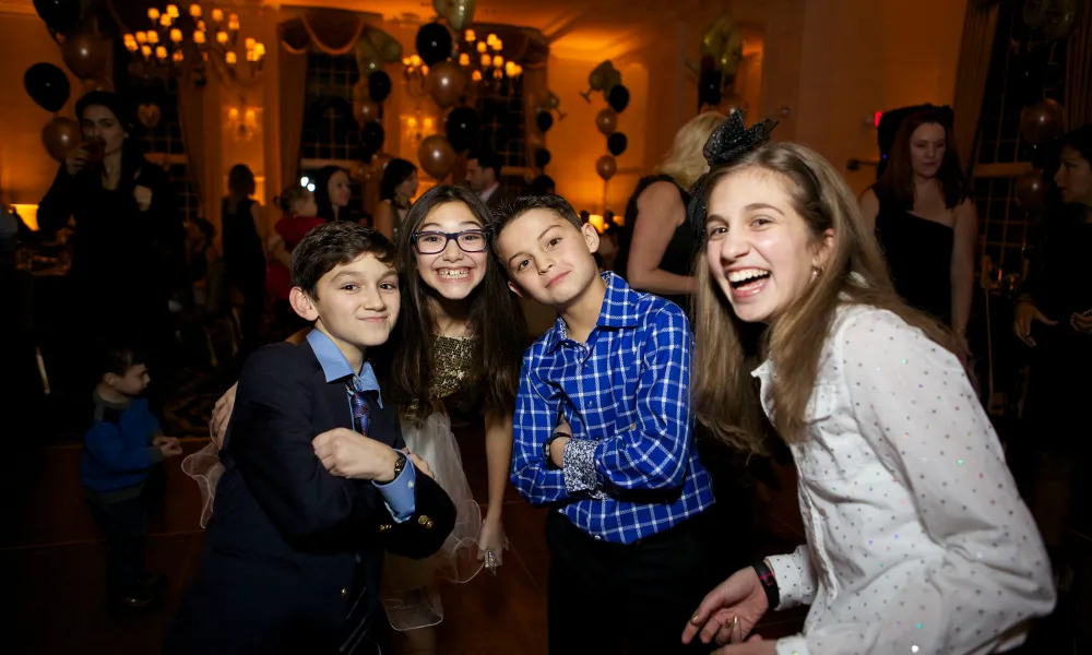 Four kids smiling at New Year's Eve celebration at Crystal Springs Resort in NJ