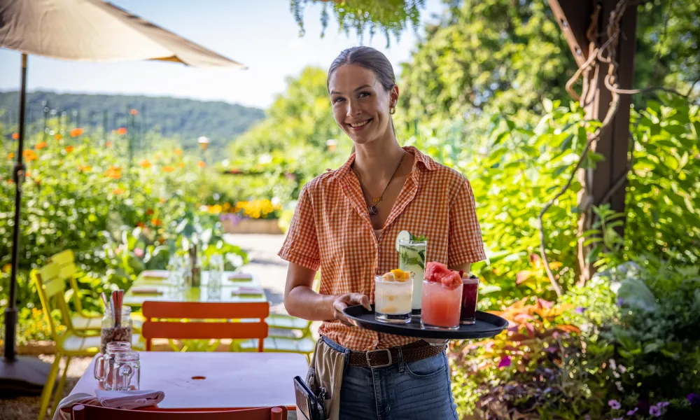 Chef's Garden server with tray of cocktails
