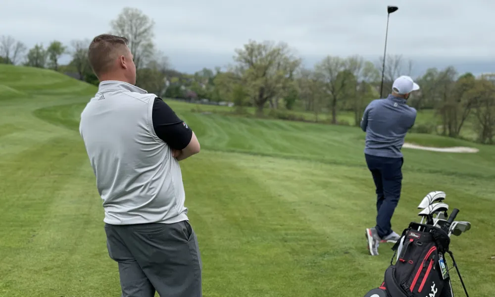 Golf instructor teaching golfer
