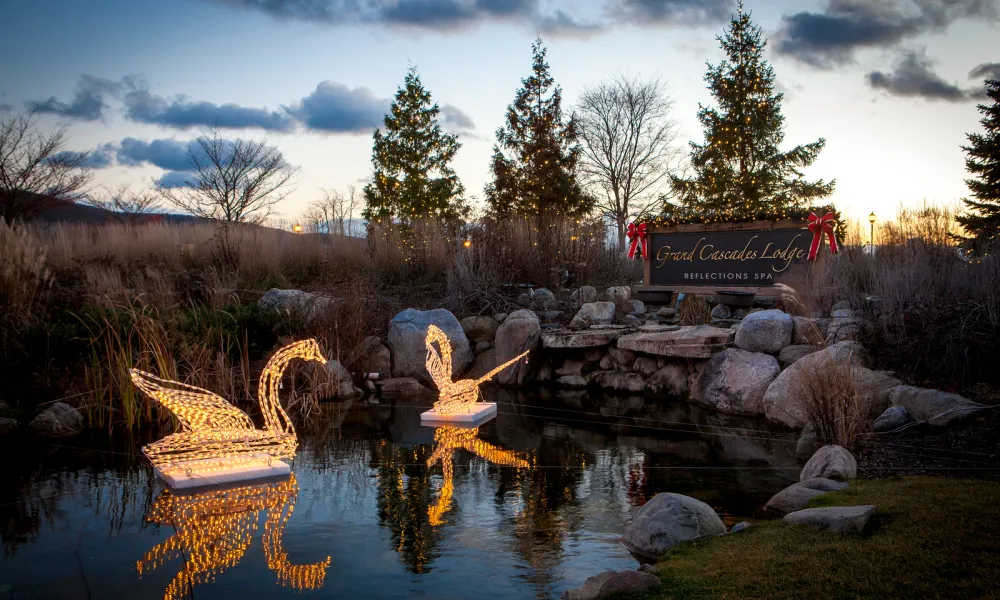 The pond in front of Grand Cascades in winter with holiday lights.