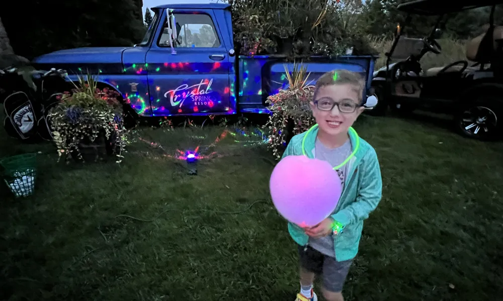 Child with glow cotton candy at Crystal Springs Resort.