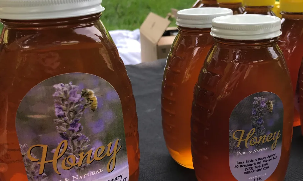 Local honey jars on table.