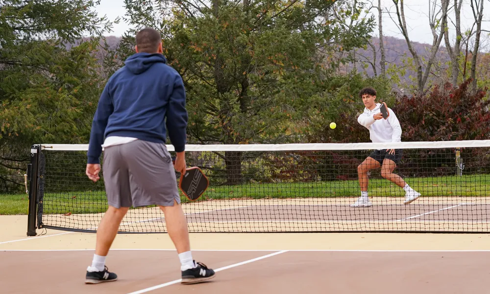 Two boys playing pickleball.