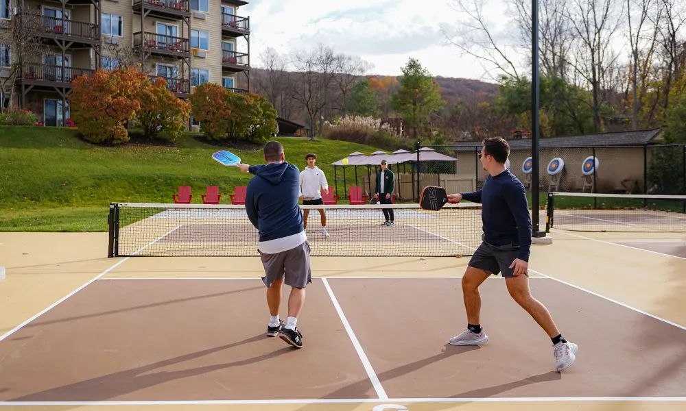 Four men playing pickleball.