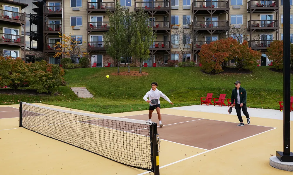 Two men playing pickleball. 