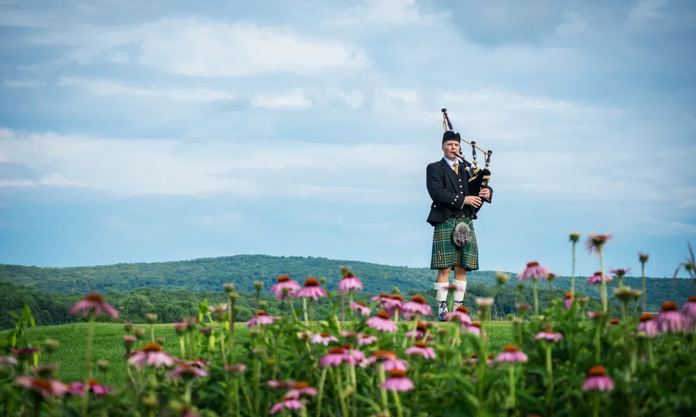 Bagpiper standing on Ballyowen Golf Course. 