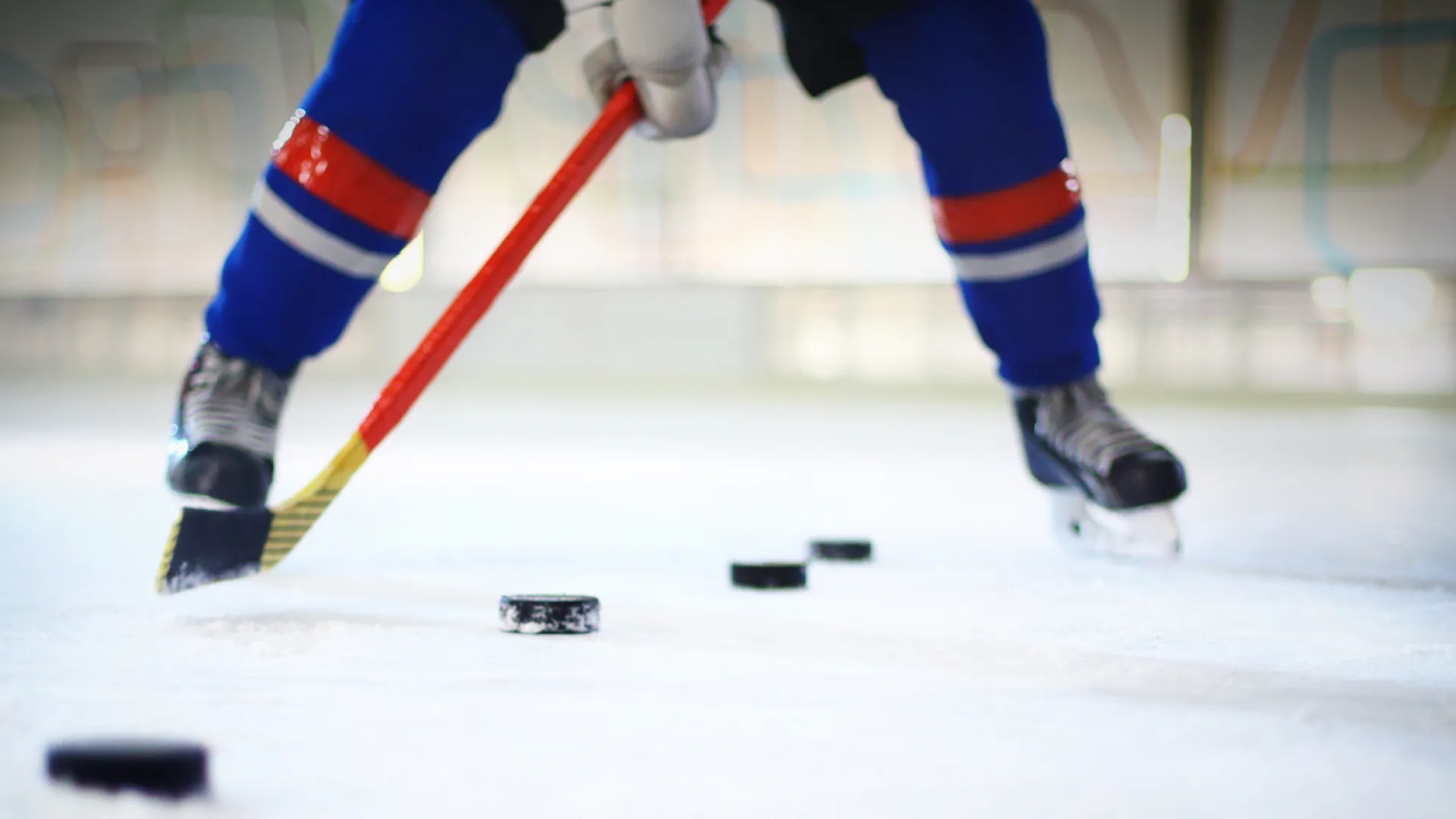 Hockey player practicing shooting hockey pucks
