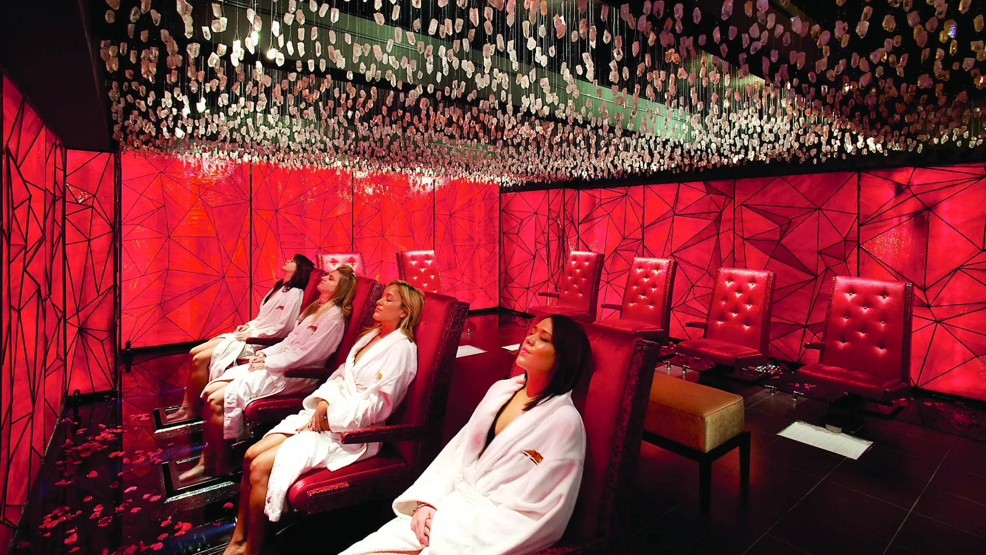 Three woman sit relaxed in chairs in Reflections Spa crystal room.