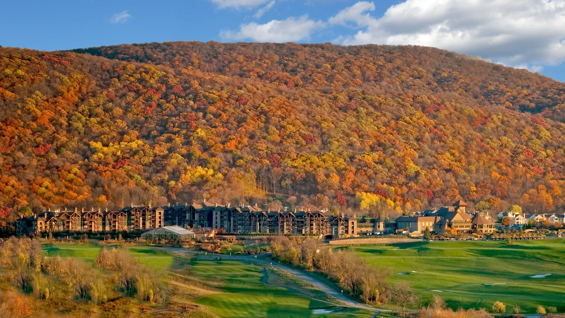 View of fall mountains behind Grand Cascades Lodge at Crystal Springs Resort in NJ